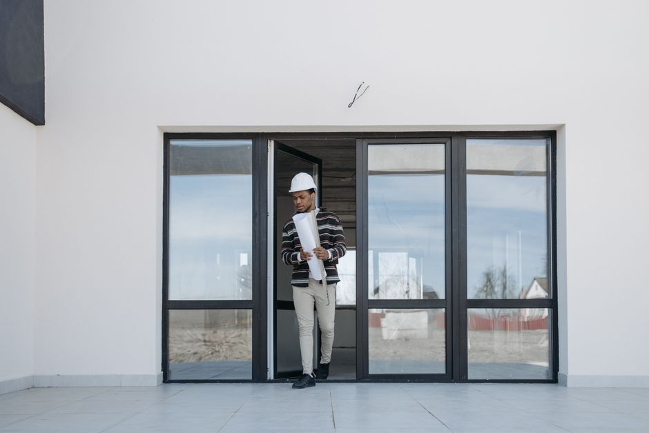 Contractor carefully measuring and installing a new residential door frame