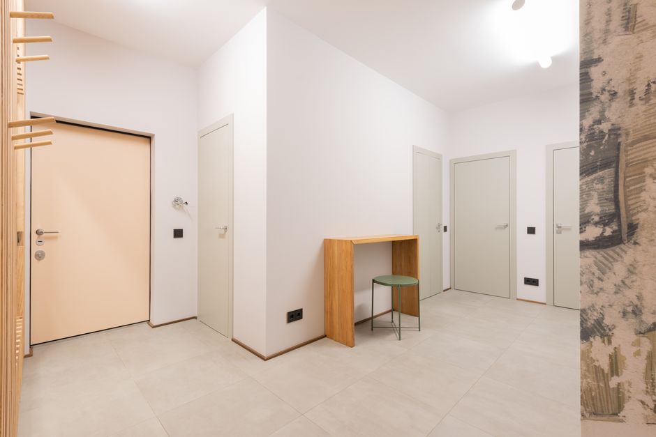 Hallway featuring newly installed white interior doors